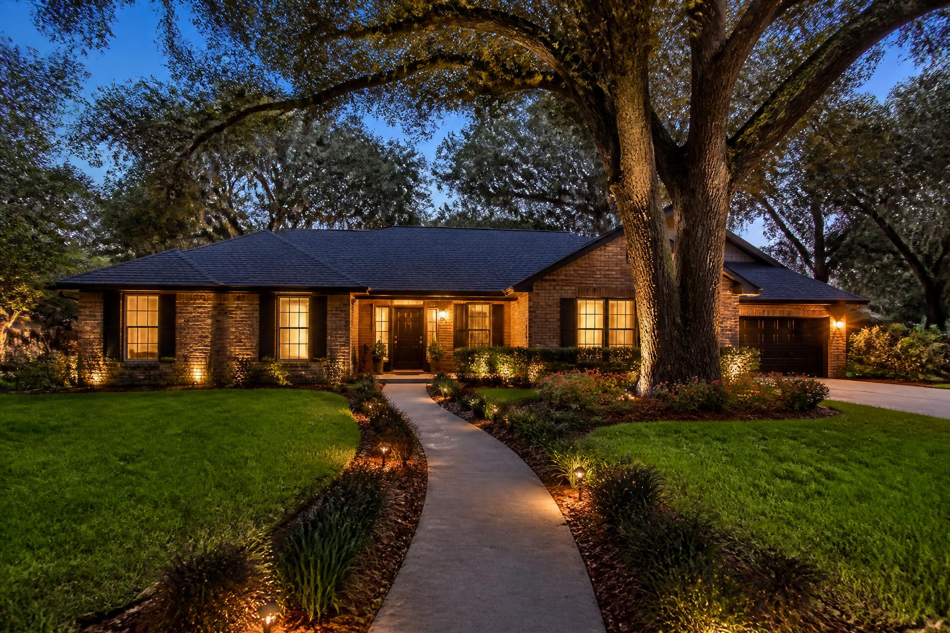 Tallahassee-area home at dusk with landscape and entry lighting illuminated